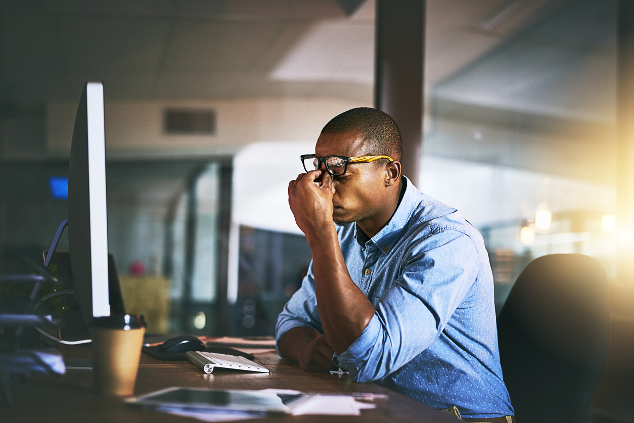 Young businessman experiencing stress during late night at work